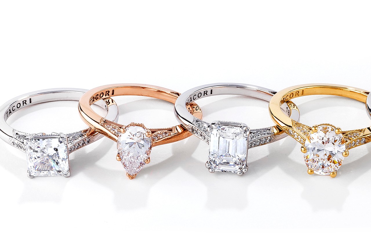 four engagement rings in a line by Tacori, all with different center stone cuts