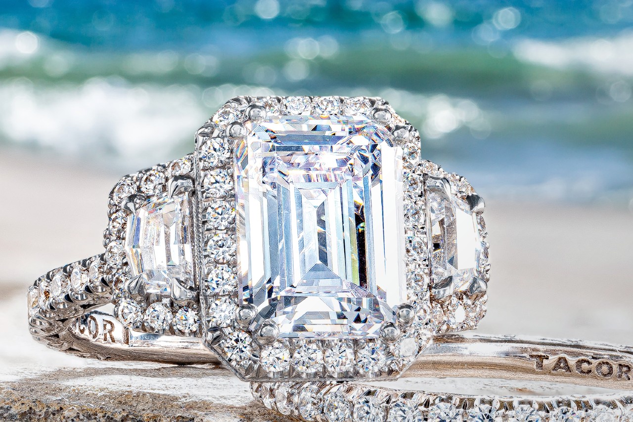 a TACORI engagement ring and wedding band depicted on a beach
