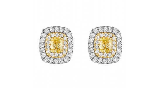 a pair of mixed metal stud earrings featuring a yellow diamond