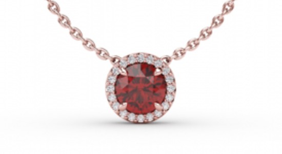 a rose gold pendant necklace featuring a round cut ruby surrounded by accent diamonds