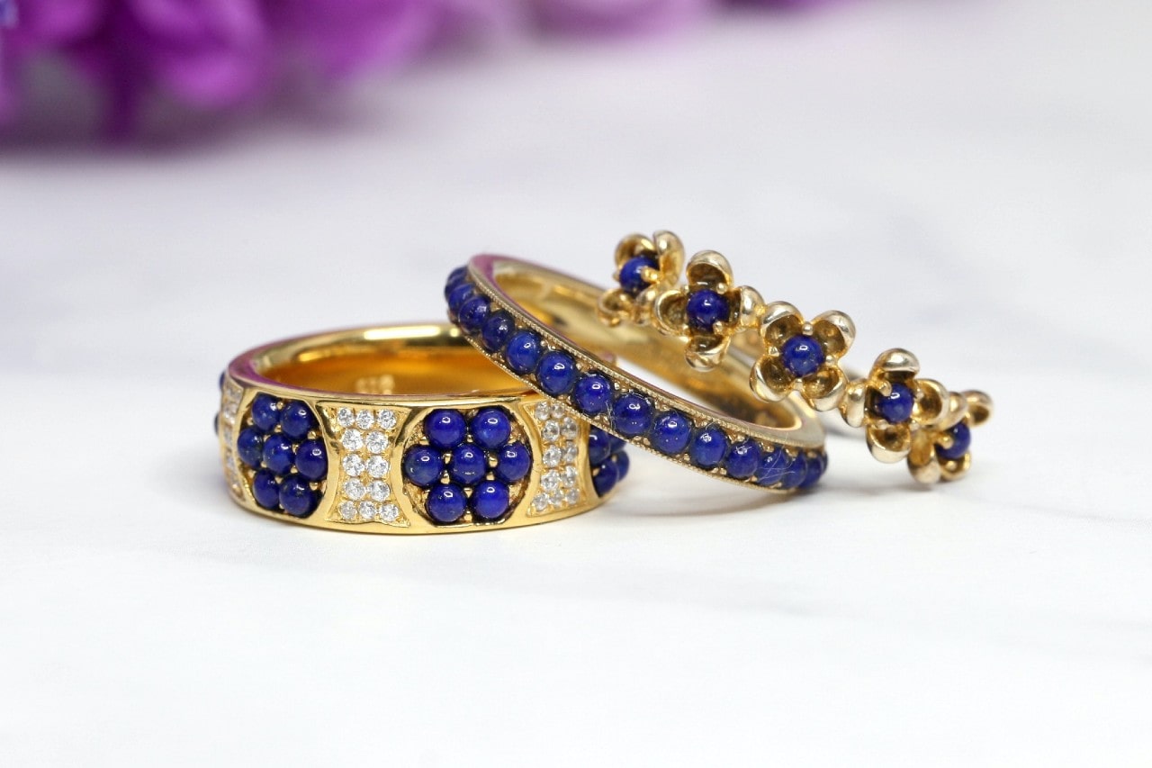 three yellow gold wedding bands set with diamond and lapis lazuli