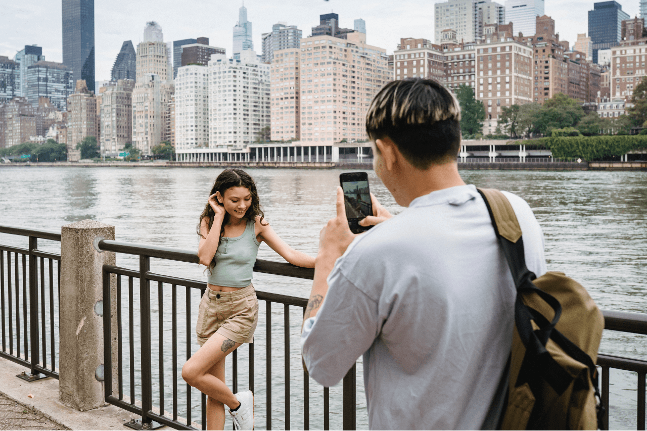 a man taking a photo of his female partner in New York