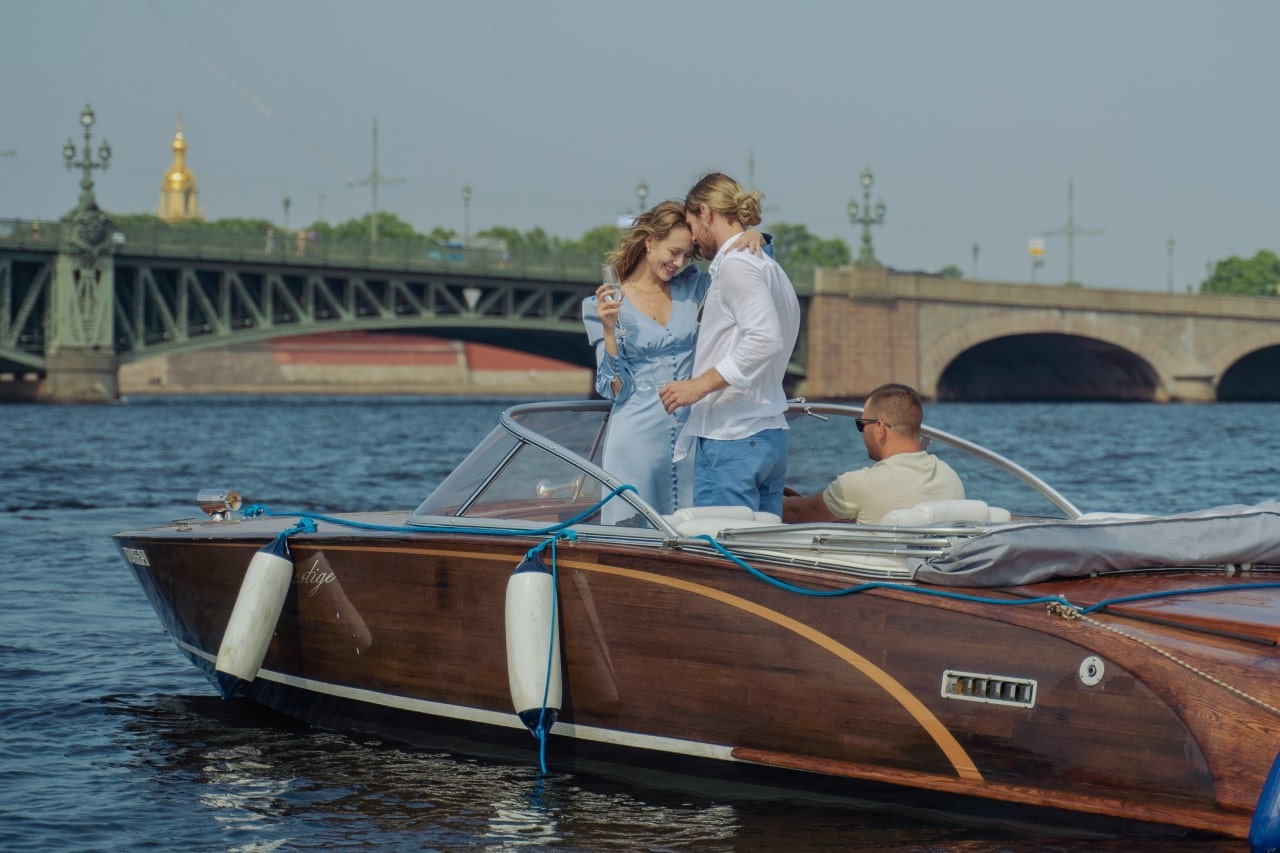 a couple on a boat drinking champagne.