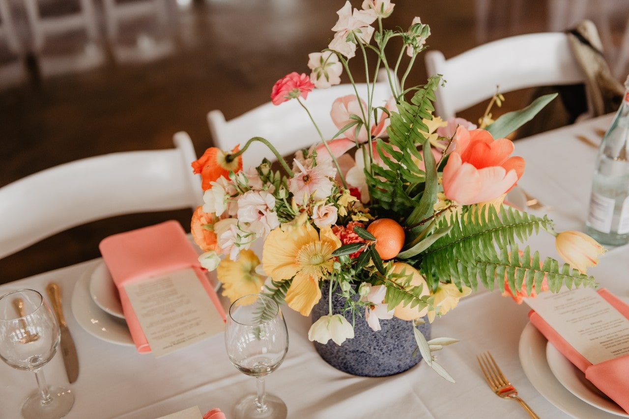 a floral arrangement on a wedding reception table