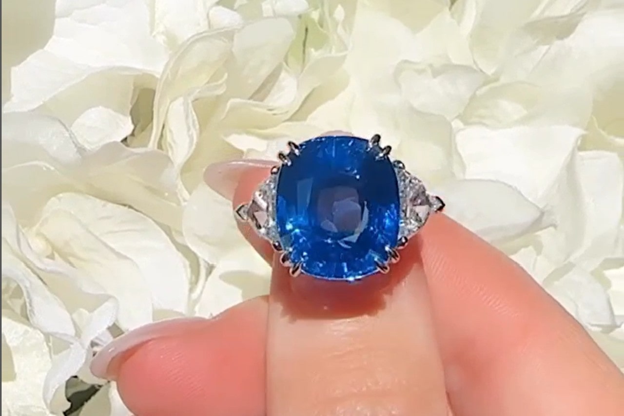 An impressive sapphire three stone ring with two diamonds on either side