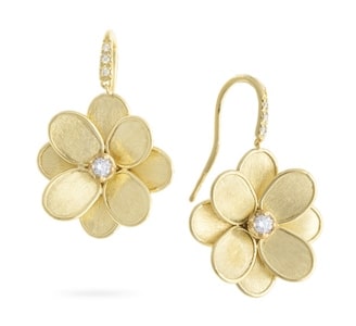 A pair of flower drop earrings from Marco Bicego feature a single diamond accent.