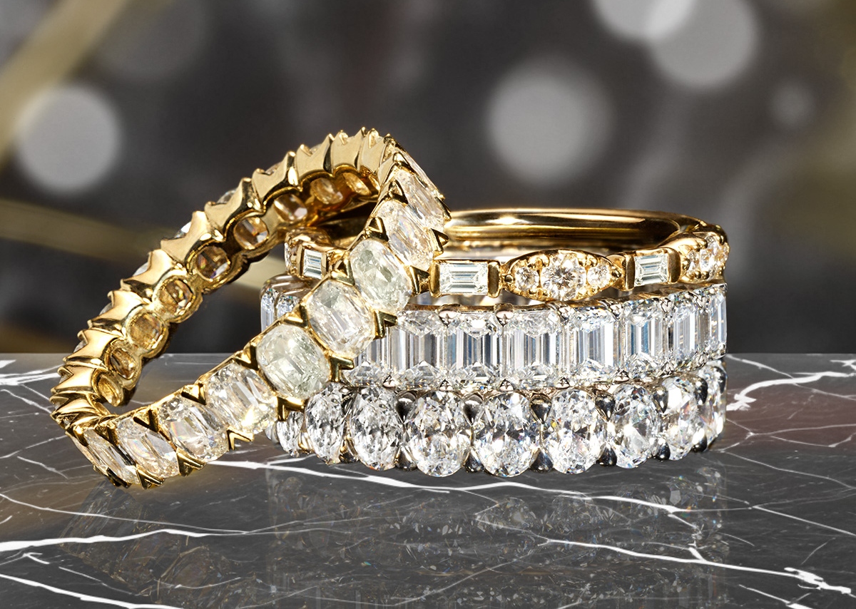 Stacked eternity diamond wedding bands in white gold and yellow gold with a variety of diamond cuts adorning the rings at BENARI JEWELERS in Exton and Newtown Square
