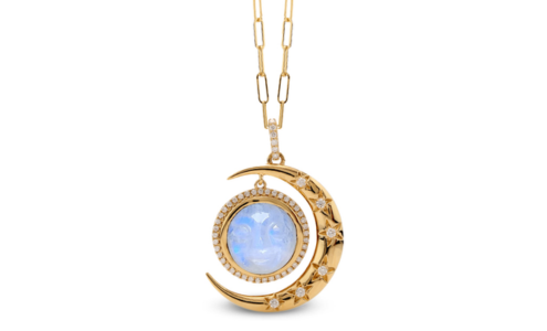 A close-up of an eye-catching yellow gold necklace with a moon pendant, available at BENARI JEWELERS.