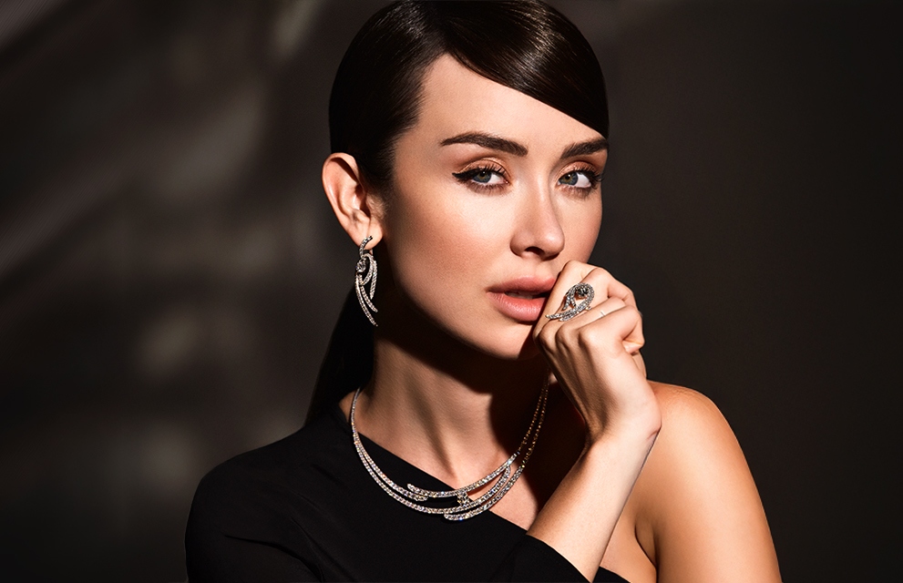 BENARI Holiday Gift Guide cover, model wearing multiple pieces of jewelry, from earrings, to a necklace, to bracelets, and rings.