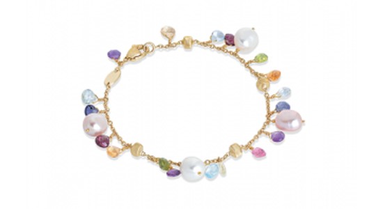 a yellow gold bracelet with various gemstones of different hues by Marco Bicego