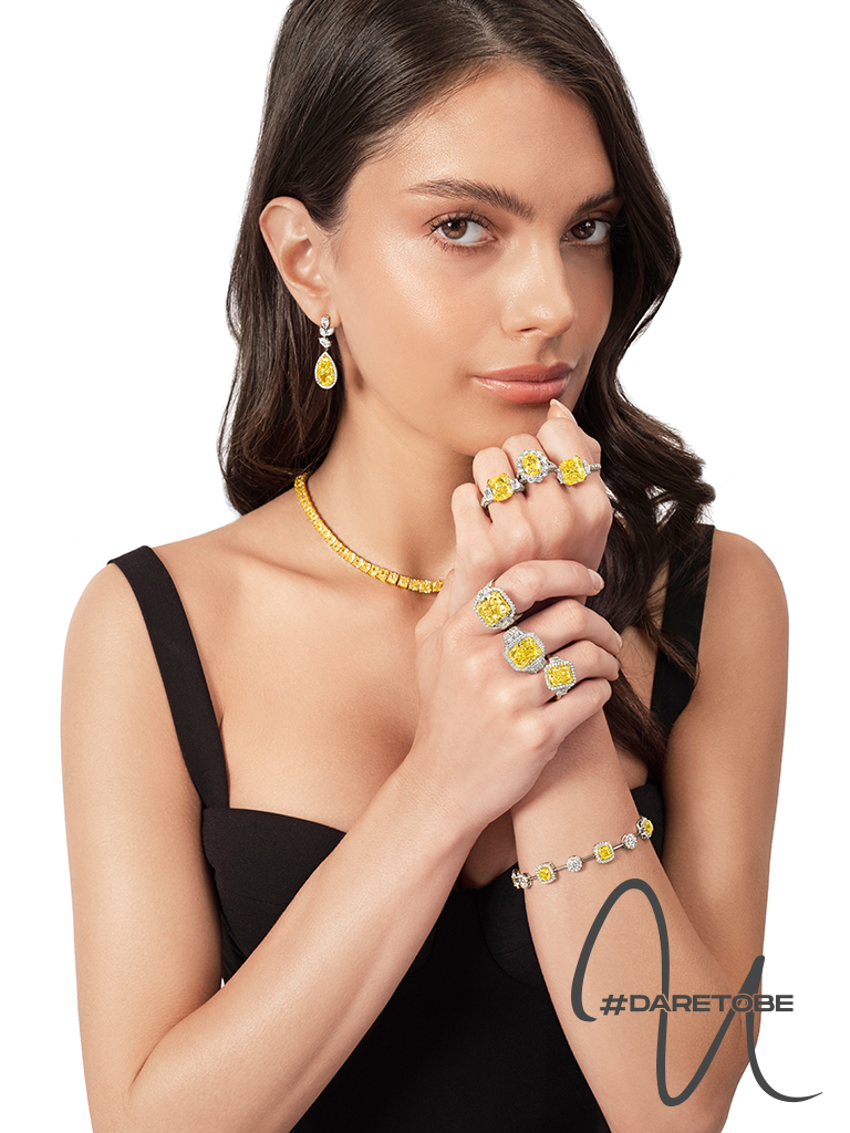 Uneek banner featuring a woman wearing Uneek fine jewelry